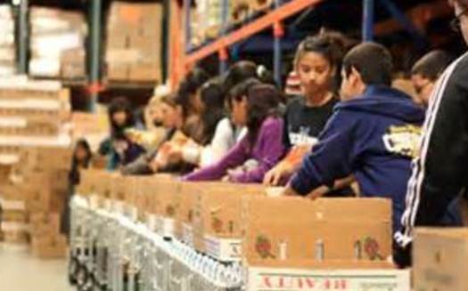 PHOTO: Volunteers fill emergency food boxes. The federal government's cuts to the Supplemental Nutrition Assistance Program, also known as SNAP and food stamps, are being felt by Arizona food banks. CREDIT: Hunger 101 AZ.