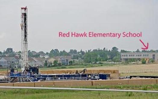 PHOTO: This photo, seen in the petition filed by Earthjustice on Tuesday, shows a Colorado school near oil and gas well sites. The petition asks for new air quality rules for drilling and fracking. Photo courtesy Lighthouse Solar.